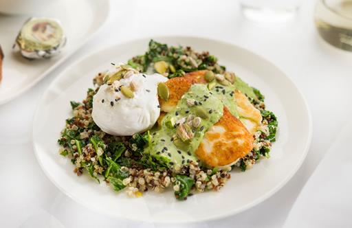 Poached eggs with kale, quinoa, grilled halloumi, pistachios, seeds and herbed tahini dressing